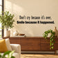 Wall decal with black quote text: "Don't cry because it's over, smile because it happened"