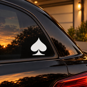 Spade decal with white spade symbol on dark car window