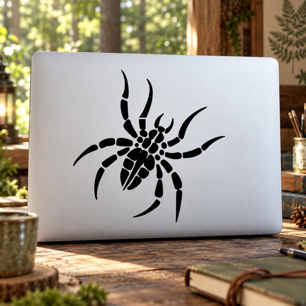 Black wobbly spider decal on a light rectangular surface