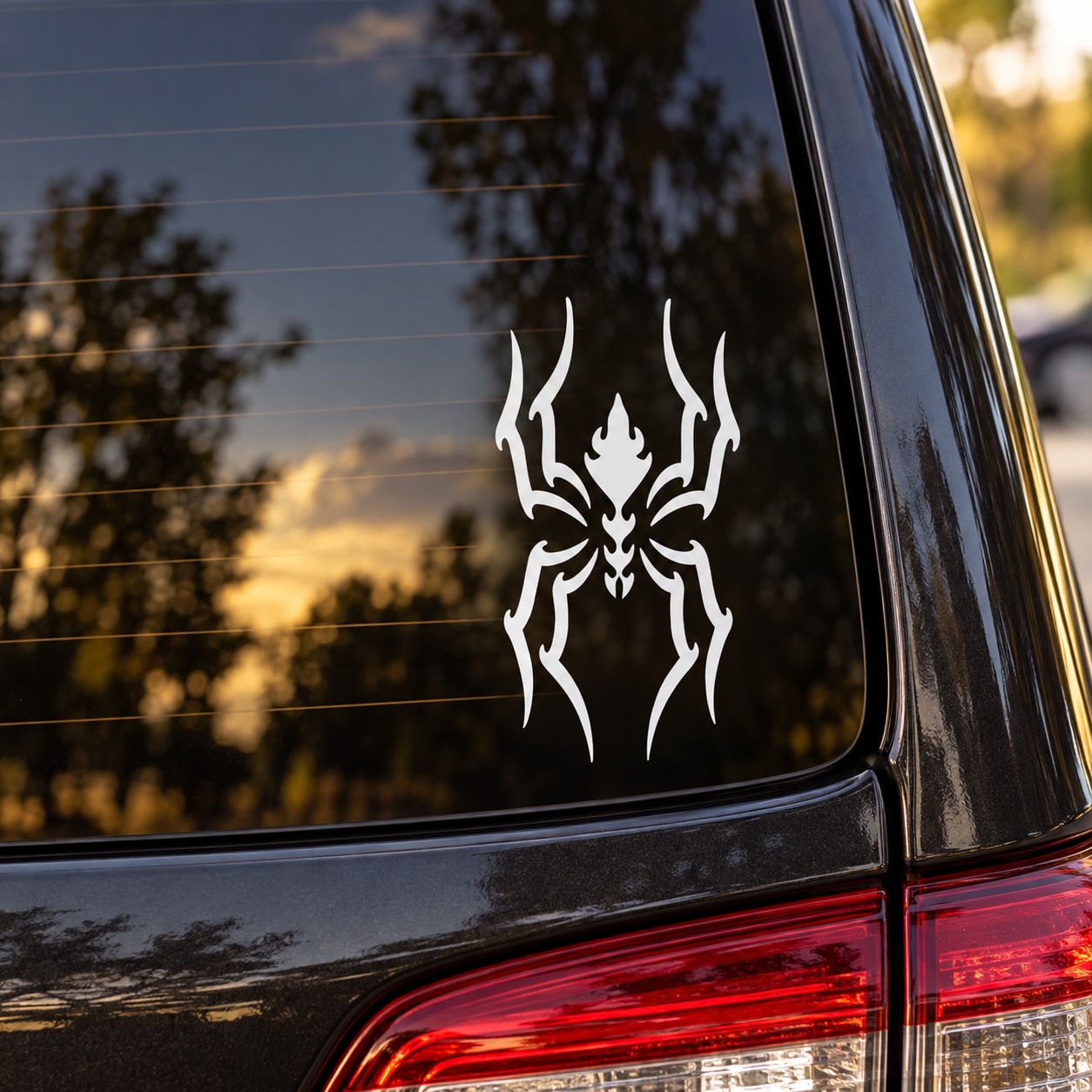 Slithering vile spider decal: white stylized spider with flame-like legs for car windows