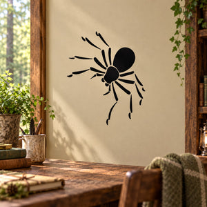 Black spider wall decal with web-like legs on light beige surface