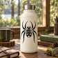Spider decal graphic: black spider design on light-colored bottle
