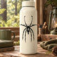 Grass spider decal with a black spider silhouette on a light surface