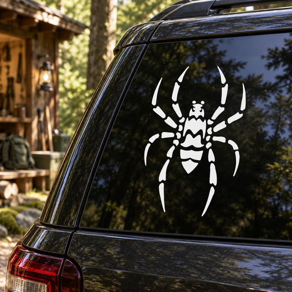 White spider decal with webbed sections on a dark car window