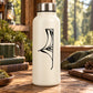White water bottle with black spider web decal