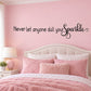 Black wall decal with “Never let anyone dull your” text and sparkle flourish