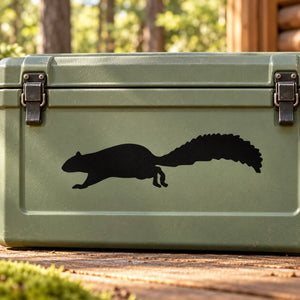 Black running squirrel silhouette decal on green rectangular surface