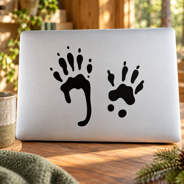 Black squirrel paw print decal with three paw prints on a light surface