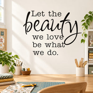 Wall decal with black cursive quote: 'Let the beauty we love be what we do.'