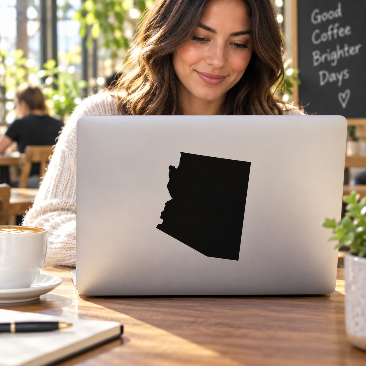Arizona state silhouette decal on laptop lid, black shape