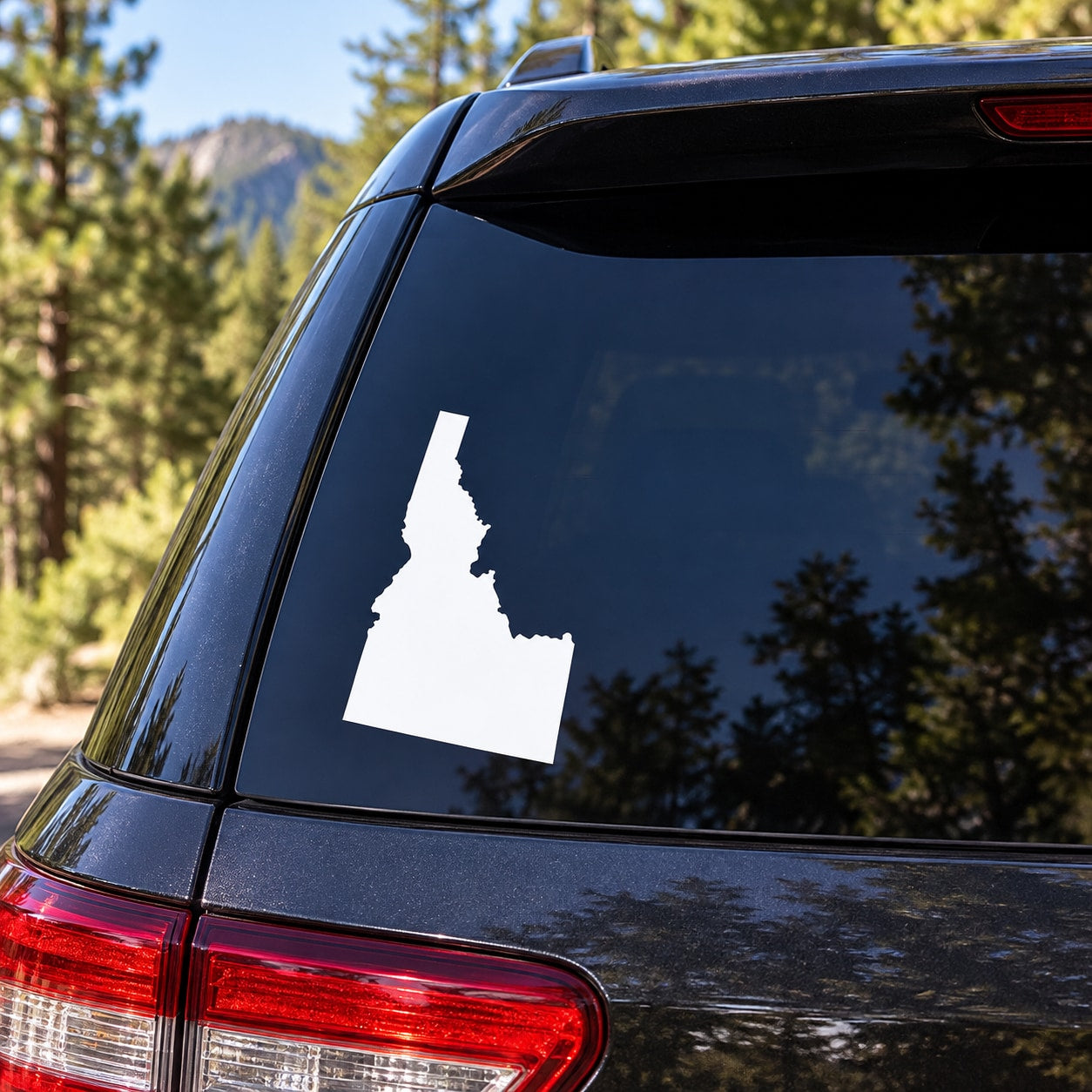 Idaho state silhouette decal on dark car rear window