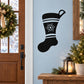 Black Christmas stocking decal with white stripe and snowflake on light blue door