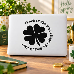 Round Irish clover decal with black four-leaf flower and curved luck text on white surface