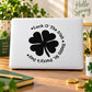 Round Irish clover decal with black four-leaf flower and curved luck text on white surface
