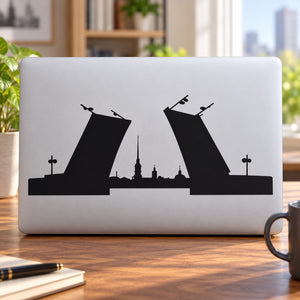 Laptop skyline decal with black city silhouette and central spire, rectangular design