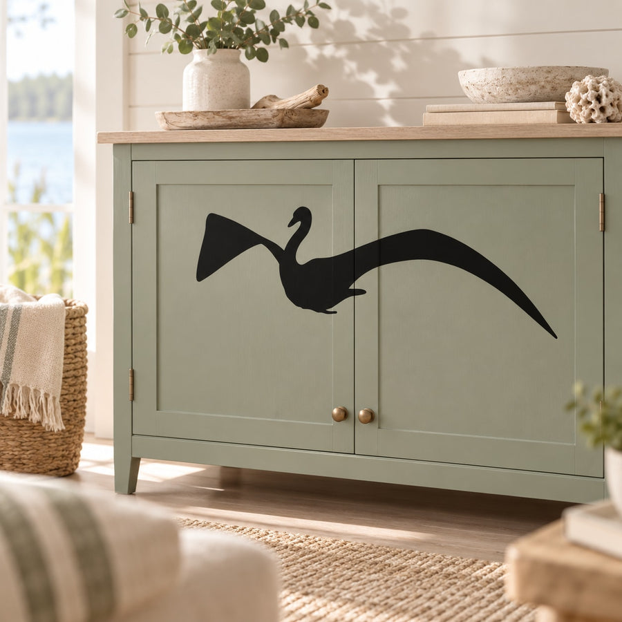 Black swan decal with wide wings on cabinet door
