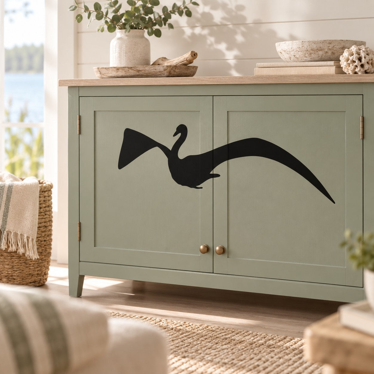 Black swan decal with wide wings on cabinet door