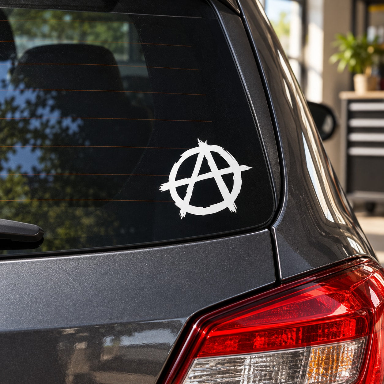 White anarchist symbol vinyl decal on car window