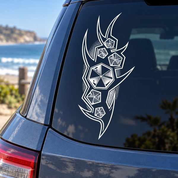 Tattoo-style vinyl car decal with white geometric emblem on a dark car window