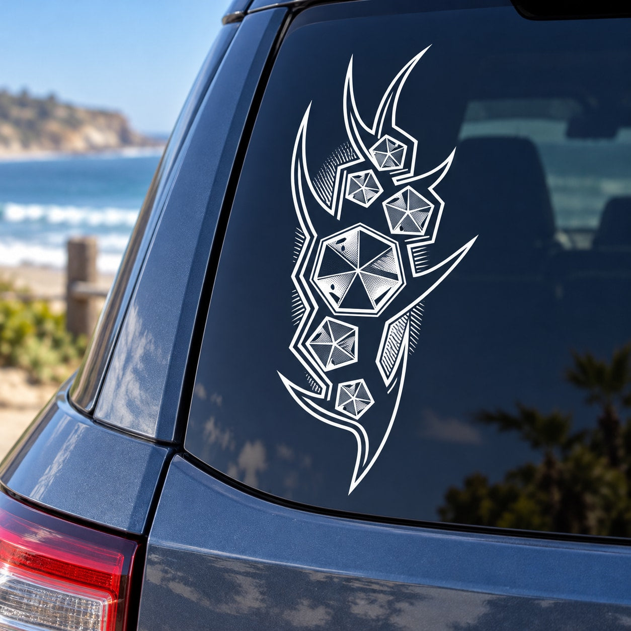 Tattoo-style vinyl car decal with white geometric emblem on a dark car window