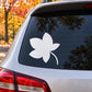 White leaf-shaped decal on car rear side window