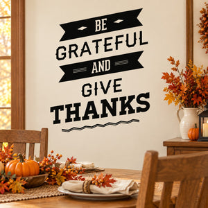 Thanksgiving wall decal: black ribbon text 'Be Grateful and Give Thanks'.