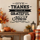 Thanksgiving typography wall decal reading “Give Thanks With a Grateful Heart” in black