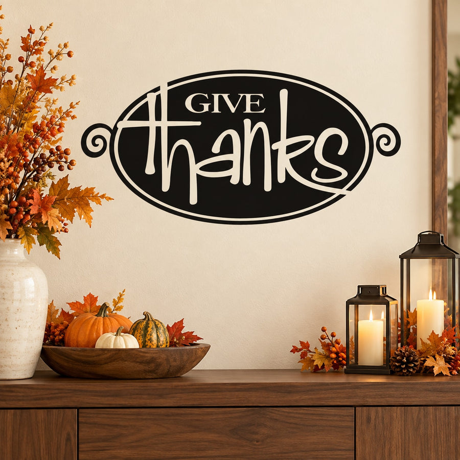 Oval Thanksgiving decal with “Give Thanks” in white lettering on a black background