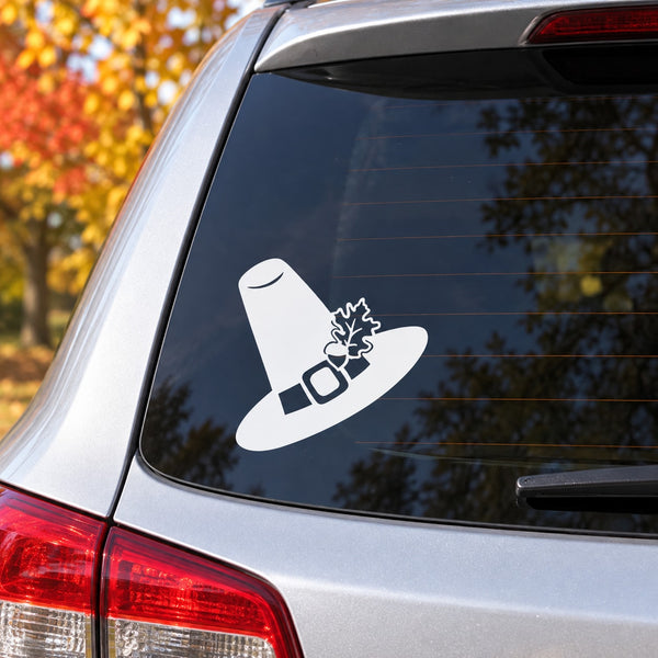 White pilgrim hat Thanksgiving decal on car window glass with leaf-style accent
