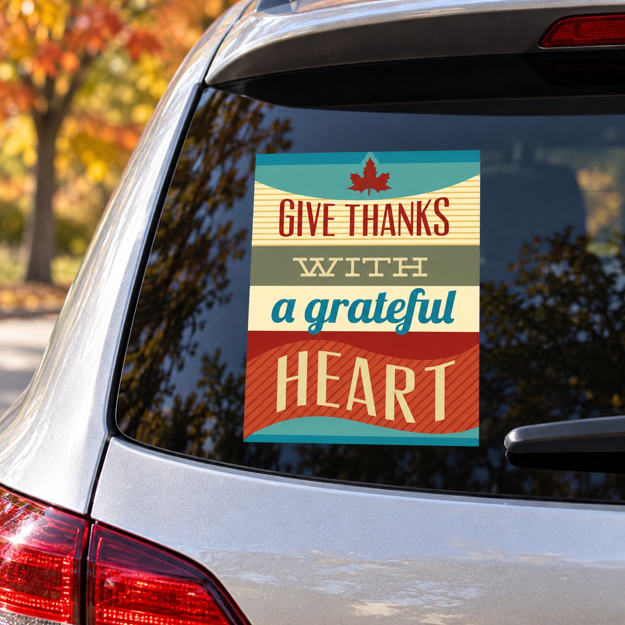 Teal and red rectangular car sticker with maple leaf and 'Give Thanks' gratitude text