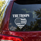 Car window decal with “THE TROOPS” text and heart flag graphic