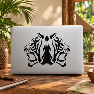 Double roaring tiger head vinyl decal in black on a light laptop lid