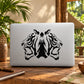 Double roaring tiger head vinyl decal in black on a light laptop lid