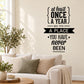Black typography wall decal: 'At least once a year, go to a place you have never been'.
