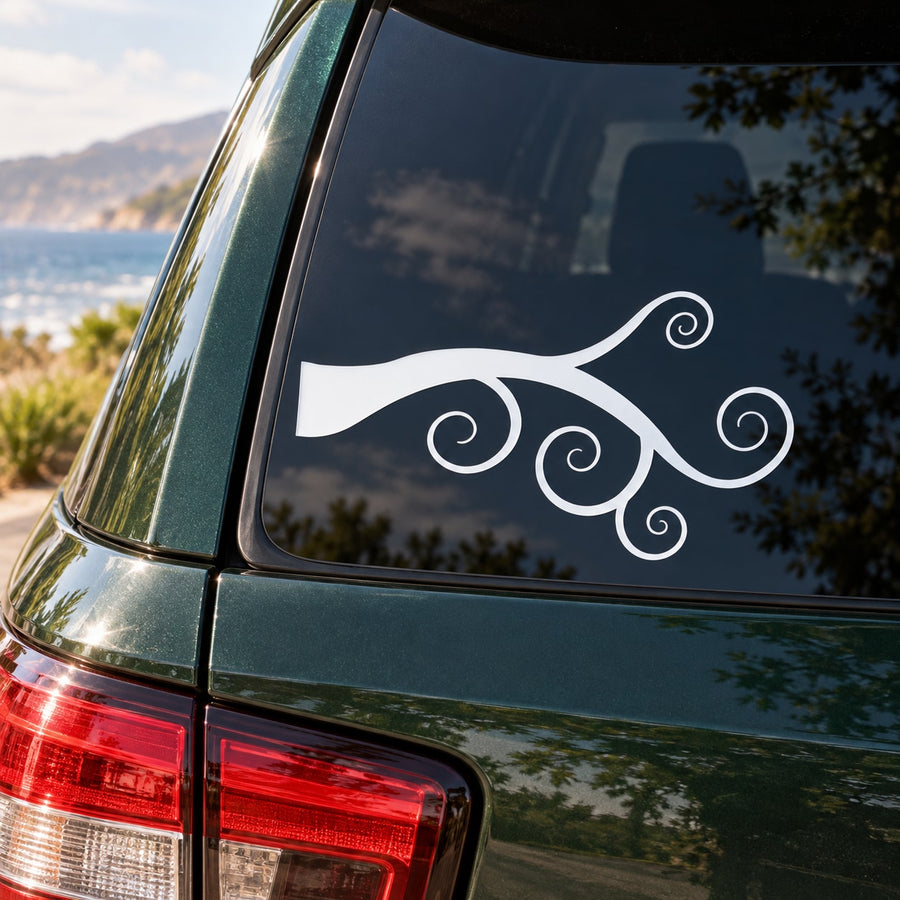 White tree branch decal with curled vines on car window.