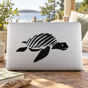 Black striped sea turtle decal on a white laptop lid