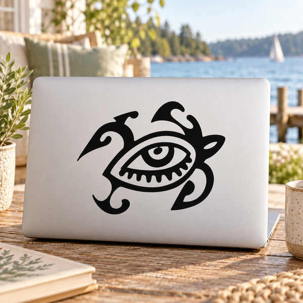 Abstract turtle eye decal in black on a light laptop cover