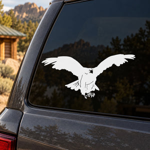 White vulture silhouette decal with wings spread on a car window