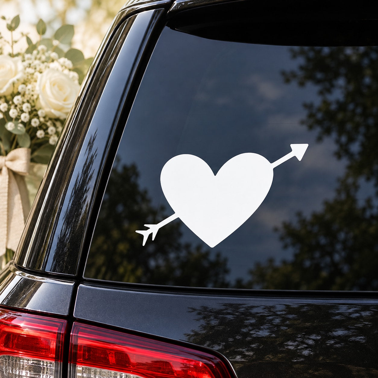 Heart with arrow symbol vinyl decal on black car window glass