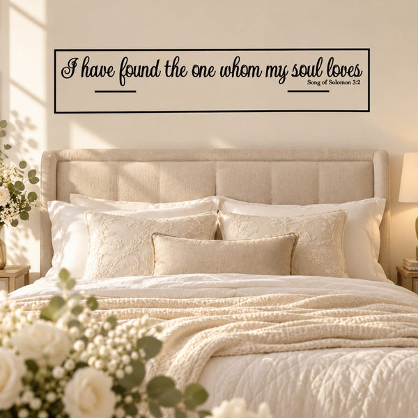 Wedding quote wall decal in black script with Bible reference, above a bed