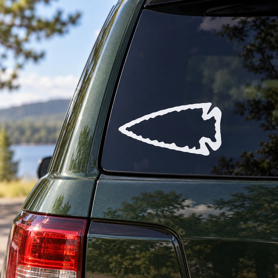 Left-pointing arrowhead decal with white outlined icon on window