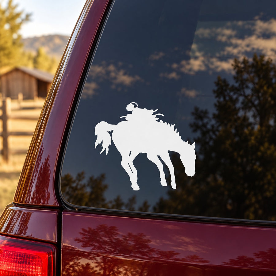 White bucking saddled horse decal on a dark car window