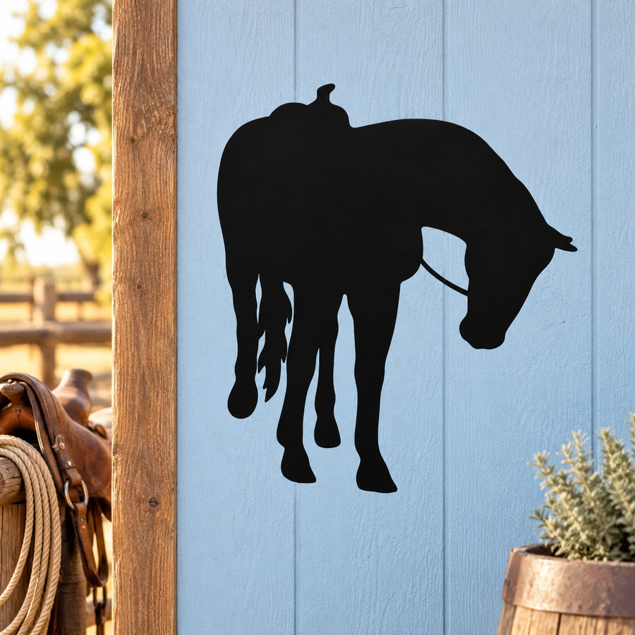 Black horse silhouette decal with saddle, facing right and looking over