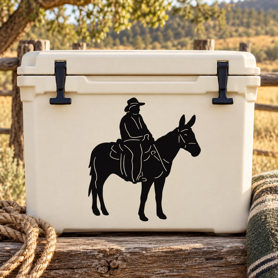 Black vinyl decal of a man riding a mule on a white cooler
