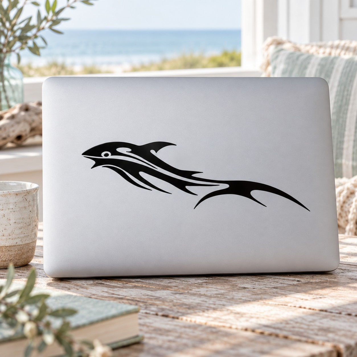 Sprinting whale decal in black, stylized on laptop lid