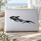 Sprinting whale decal in black, stylized on laptop lid