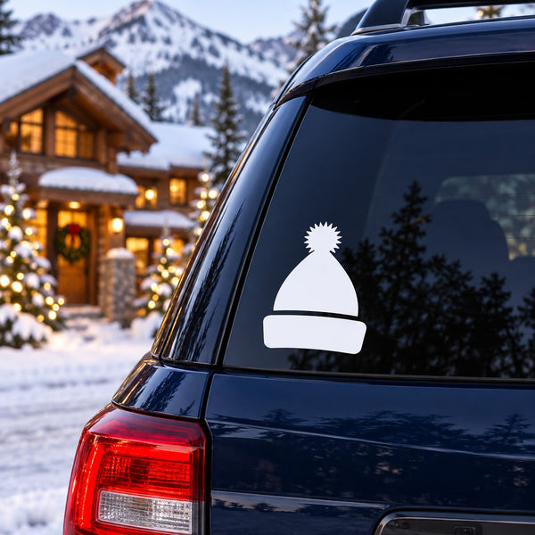 White beanie cap decal on dark car window, winter hat silhouette