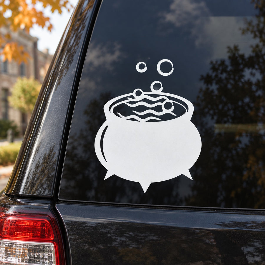 White cauldron and bubbles decal on dark car window