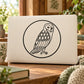Geometric owl decal in a circle, black line art on light background.