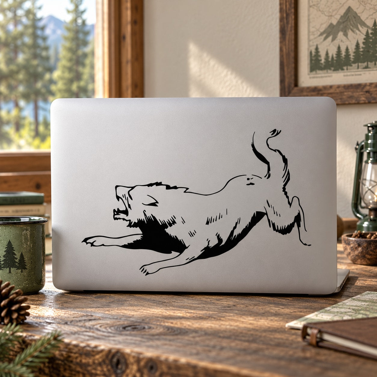 Agitated snarling wolf decal in black line art on a light laptop